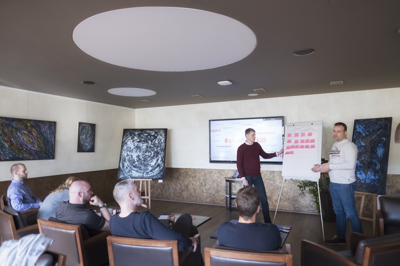Michal Juhas presenting at a flipchart during a small-group workshop (2018)